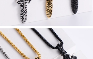 Detailed macro view of vintage cross pendants in silver, gold, and black steel finishes