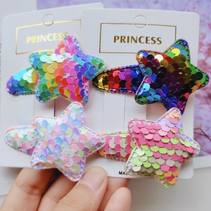 Detail of four colorful star-shaped hair clips with sequins on Princess gift cards
