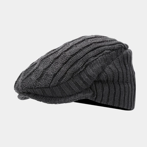 Detail of dark grey cable knit pattern and ribbed edge on a warm winter ivy cap