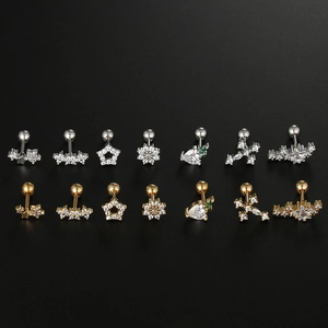 Detailed close-up of gold and silver stainless steel ear studs with zircon star and heart shapes
