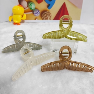 Set of four large jelly colored hair claws with ribbons in various translucent finishes