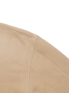 Close-up detail of premium beige fleece fabric texture and high-quality stitching