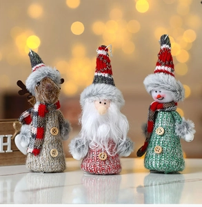 Detailed view of handmade knitted Christmas elk, Santa, and snowman plush figurines