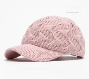 Close-up of pink cable knit baseball cap showing thick texture and ribbed brim detail