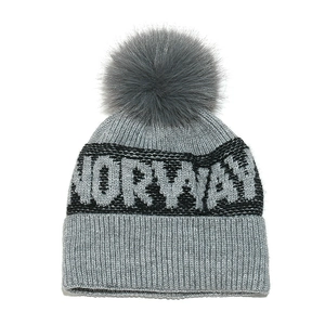 Detailed close-up of grey knit beanie with Norway text and a fluffy faux fur pompom