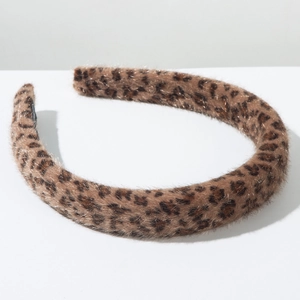 Close-up of leopard print headband with soft faux fur texture and autumn plush material