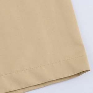 Macro shot of khaki twill fabric texture and stitching detail on the elegant dress hem