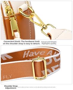 Detail of two-tone leather bag with golden hardware and wide woven lettered strap