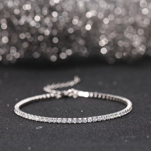 Macro shot of silver tennis bracelet with cubic zirconia inlay and adjustable chain