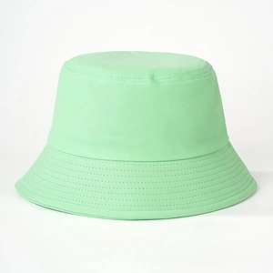 Detail showing mint green cotton bucket hat with clean stitching and wide brim