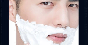 Close-up of thick white shaving foam on male face demonstrating rich creamy texture