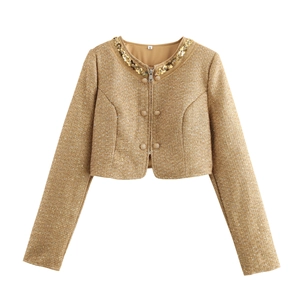 Detail of tweed jacket neckline featuring sequins, bead embellishments, and zipper closure