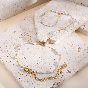 Detail showing gold 18K plated chain with pearls, lobster clasp and extension link