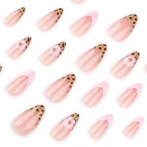 Long almond press-on nails with leopard print, 3D pink texture, and floral metal accents