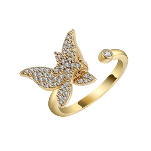 Golden butterfly spinner ring with sparkling cubic zirconia on a minimalist white band