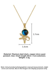 Macro detail of astronaut pendant with crystal pavé and blue starry galaxy helmet
