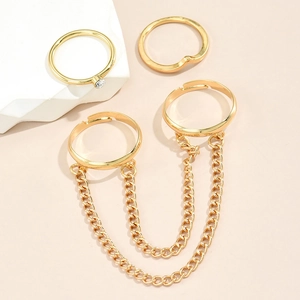 Detail of gold chain ring set with stars, butterfly sequins and clear rhinestones