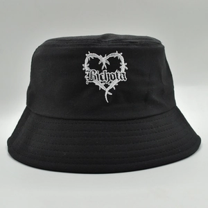 Black cotton bucket hat featuring white Bichota embroidery and barbed wire heart design