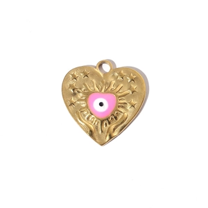 Detail of a gold heart pendant with a pink evil eye enamel and embossed star pattern
