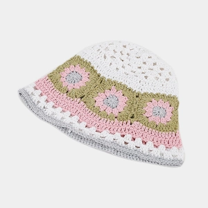 Close-up of handmade crochet hollow floral pattern on a knit bucket hat with cotton texture