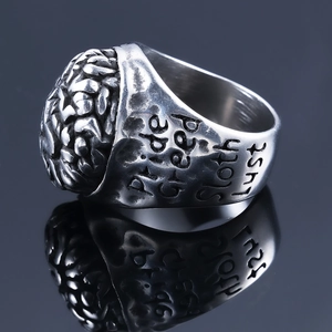Macro detail of Seven Deadly Sins ring showing engraved Pride text on steel