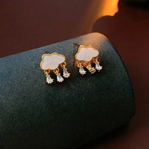 Elegant gold cloud earrings with white enamel and three sparkling zircon teardrop charms