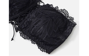 Close-up of black lace bandeau bra showing intricate floral embroidery and tie-up details
