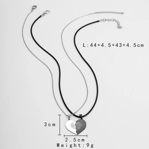 Detailed view of stainless steel heart puzzle necklace with fingerprint texture and dimensions