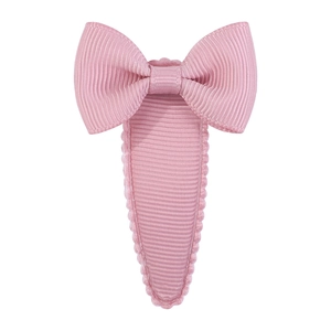 Detailed view of pink grosgrain ribbon bow hair clip with wavy stitched scalloped edges