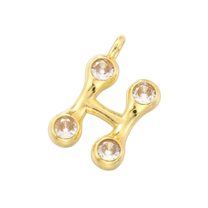 Macro detail of 18K gold plated letter H pendant with four round clear gemstones