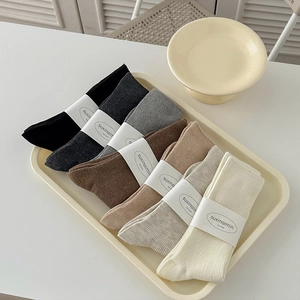Minimalist cotton crew socks set in neutral earth tones with ribbed knit texture