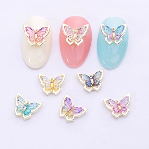 Detailed macro view of 3D colorful butterfly nail charms on different nail polish colors