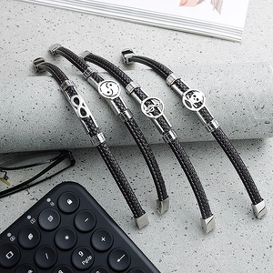 Men's set of four braided leather bracelets featuring infinity and skull metal charms