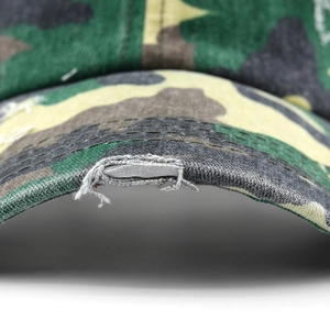 Close-up of distressed brim on camouflage ponytail baseball cap with vintage worn details