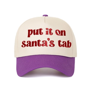 Close-up of Put It on Santa's Tab red embroidery on a cream and purple baseball cap