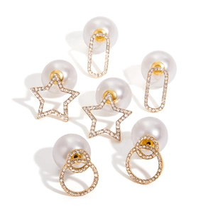 Three pairs of gold pearl earrings with rhinestone stars and oval shapes on white backdrop
