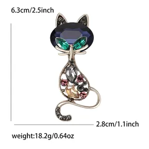 Elegant vintage cat brooch with blue gemstone and colorful crystals in golden metal finish