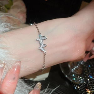 Detailed view of an elegant silver butterfly bracelet with sparkling zircon stones