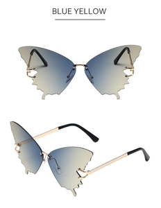 Detail of butterfly rimless sunglasses with blue-yellow gradient lenses and gold frames