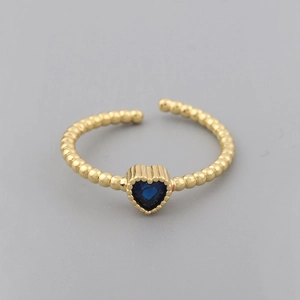 Macro shot of 18k gold plated ring featuring blue heart zircon and beaded texture