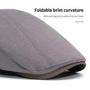 Minimalist grey flat cap with foldable long brim for face contouring on white background