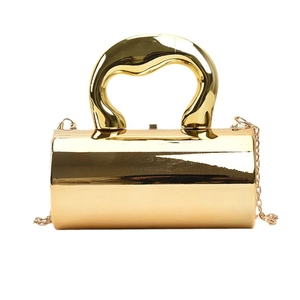 Glossy gold cylindrical evening bag with large wavy handle and gold chain strap