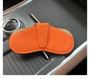 Litchi texture orange faux leather glasses pouch with white stitching for car console storage