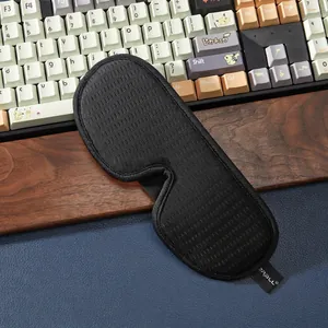 Close-up of 3D breathable sleep mask with ergonomic nose wing on a textured surface
