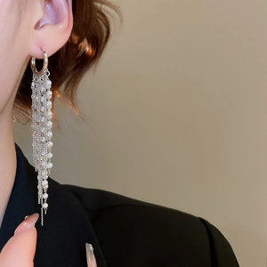 Close-up of 18k gold plated long pearl tassel earrings on model with elegant drop design