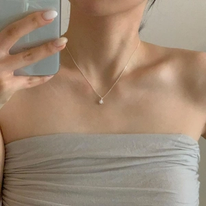 Mirror selfie showing the star pendant necklace on the collarbone for fit and style
