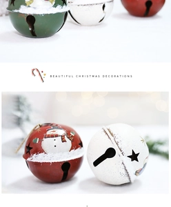 Close-up of vintage metal Christmas bells with snowman prints and star cutouts