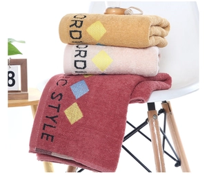 Detail of soft cotton bath towels with geometric diamond patterns in Nordic style