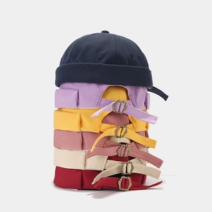 Close-up of adjustable metal buckles and canvas texture on multi-color miki hats
