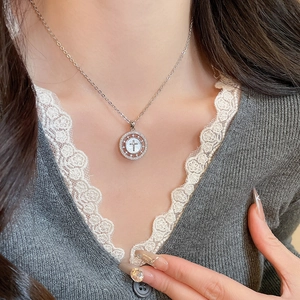 Détail du pendentif croix plaqué or 18K avec nacre et zircons brillants